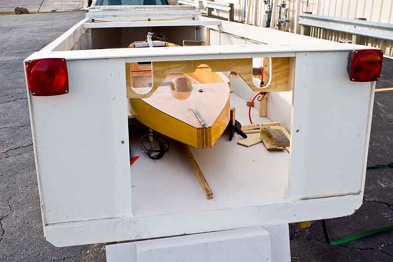 IMG_8540_800w.jpg - WIth the rear-panel removed, the stern of the hull easy to reach. The rear of the hull sits on two plaforms with a bunge cord holding it down, and two pins through the plank-attach plate keeping it in position.